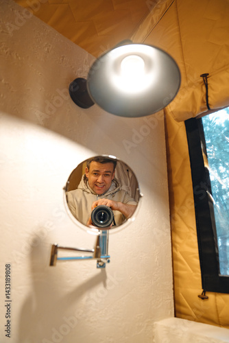 Obraz na płótnie Lamp and round mirror in the bathroom in the tent house in the glamping. w salonie