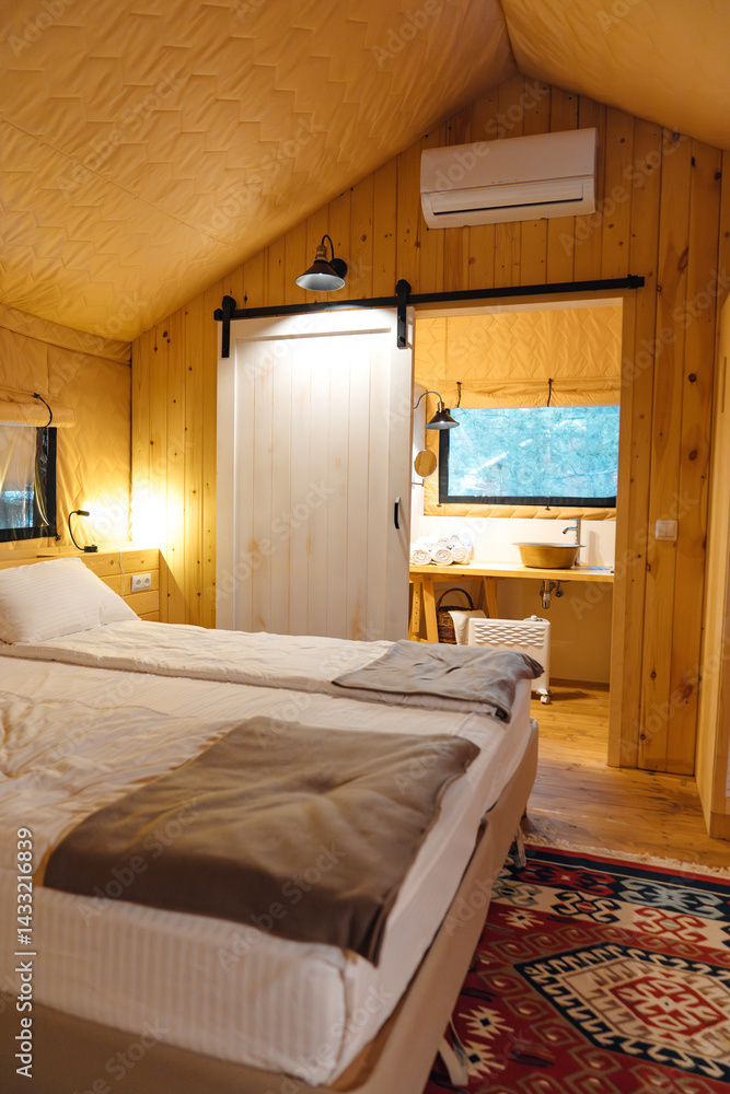 Bedroom interior in glamping. A cozy tent house.
