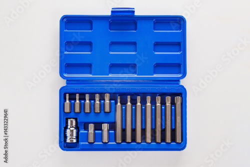 A set of single-sided chrome steel bits in a blue plastic box 