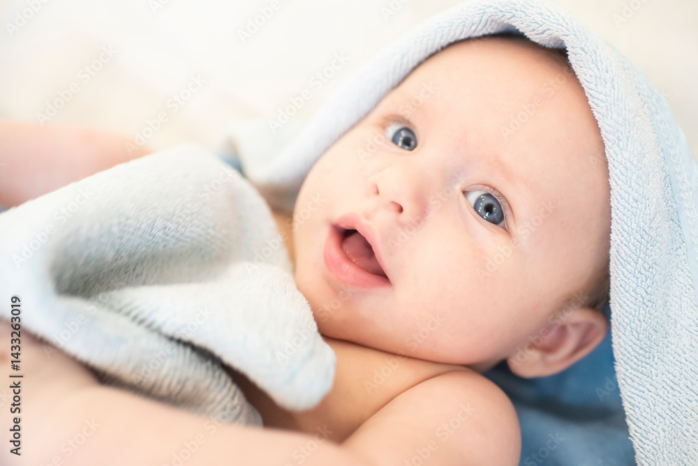 Portrait of a baby boy in a towel. The child is 3 months old. Portrait of a baby boy in a towel. The child is 3 months old.