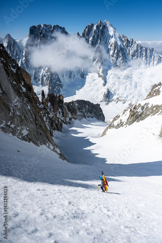Mountaineer Carrying Skis Across Snowy Glacier in Chamonix Alps, France.  Winter Adventure Landscape