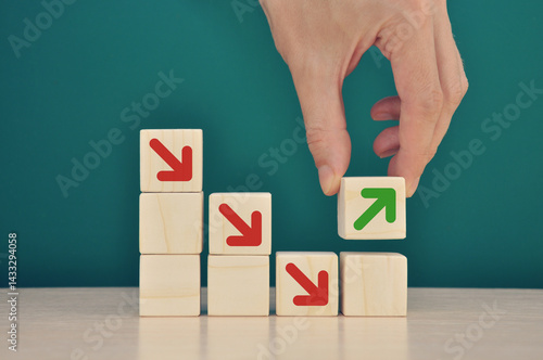 Businessman stacking wooden blocks into growing successful financial char
