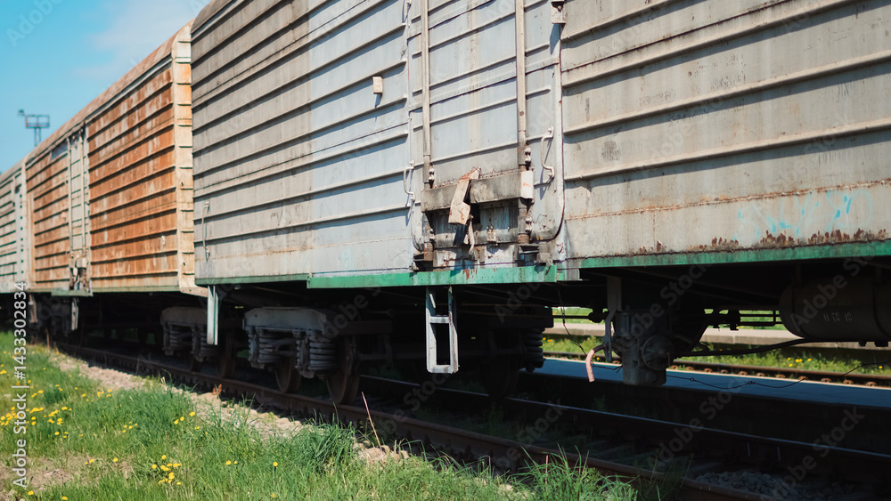 Naklejka premium Close up view of old freight train at railway station in urban environment