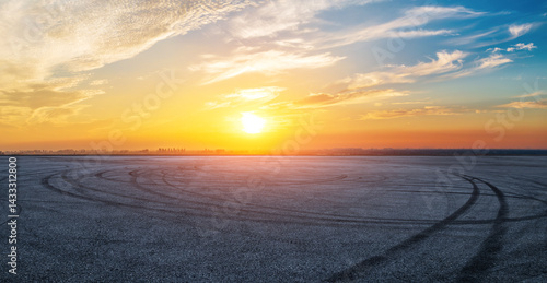 Asphalt road and skyline with beautiful sky clouds at sunset
