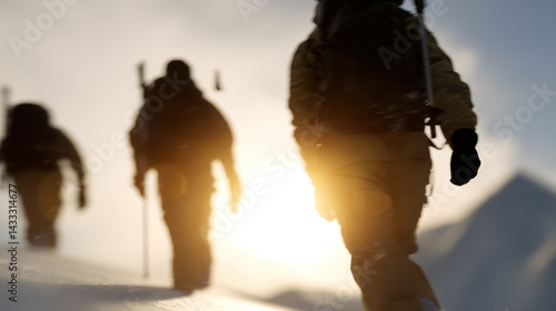 Hikers traverse snowy landscape, silhouetted against bright sunrise, showcasing determination and adventure in winter wilderness