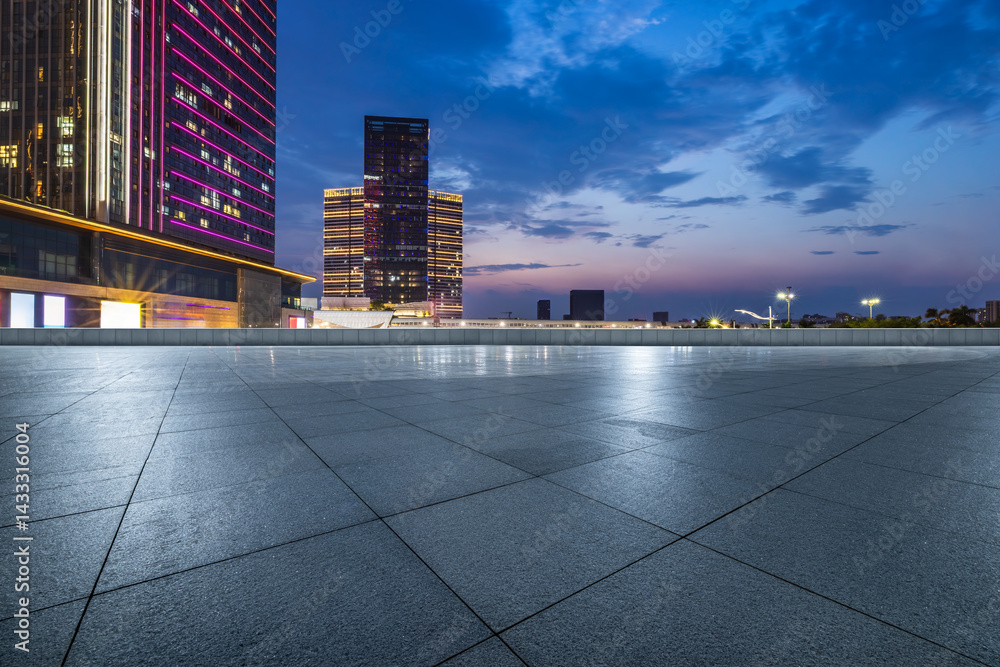 Empty square floor and modern city buildings at night