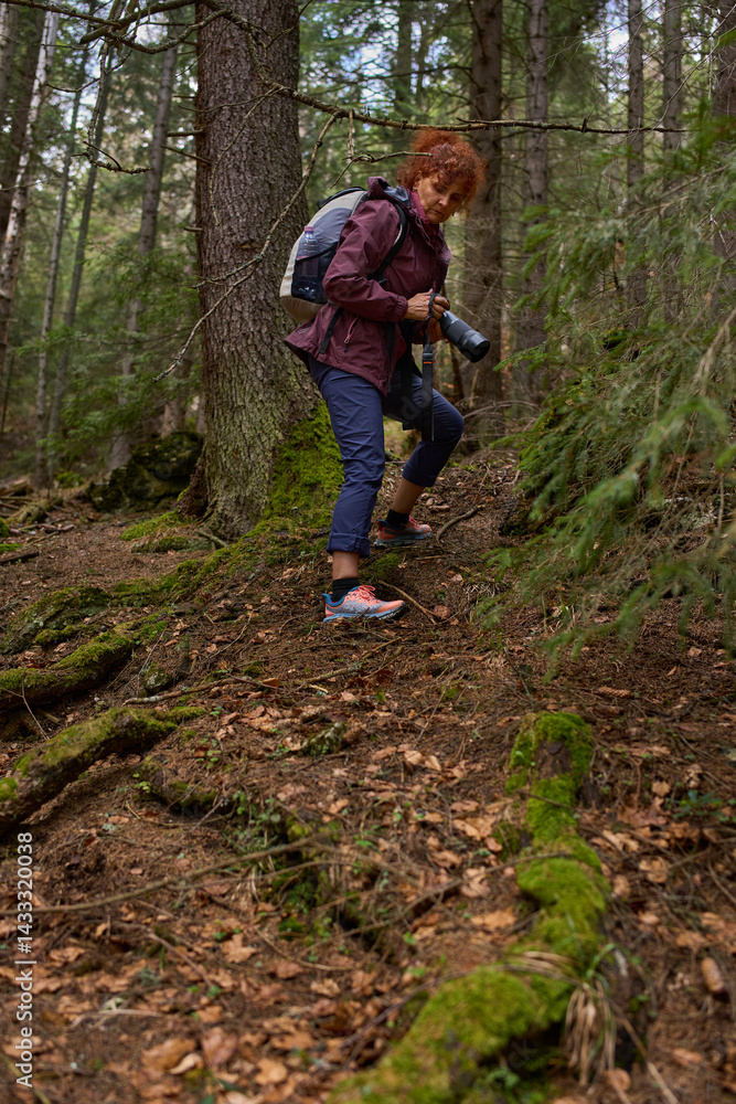 Photographer descending forest slope