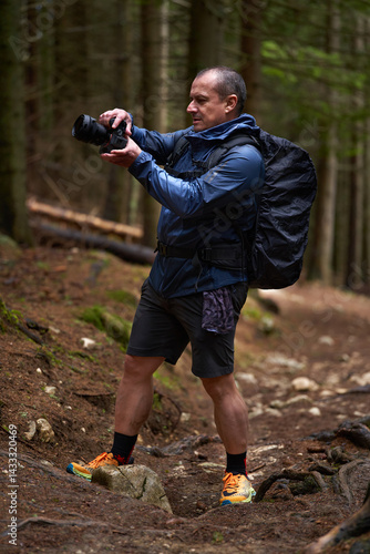 Man photographing forest trail with camera
