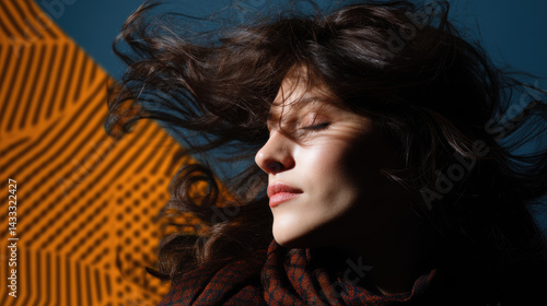 Obraz na płótnie woman with flowing hair is captured in slow motion against vibrant background, showcasing sense of freedom and beauty. dramatic lighting enhances her features and movement of her hair w salonie