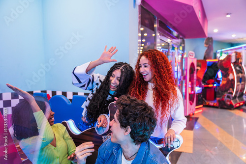 Group of young friends enjoying their time playing arcade games in a bowling alley and entertainment center
