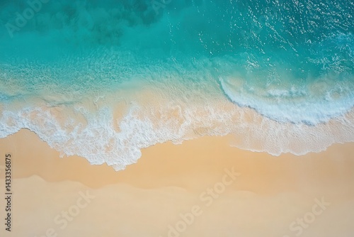 High-angle view of a tranquil beach with turquoise waves lapping at the shore.