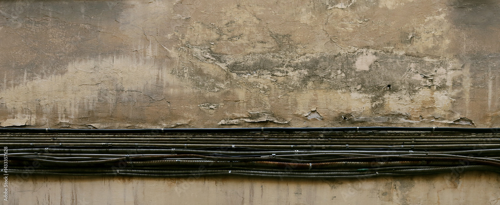 Electrical cables on the background of an old wall Electrical cables on the background of an old wall