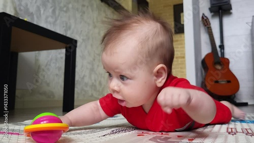 A Four-Month-Old Girl Cannot Reach The Rattle