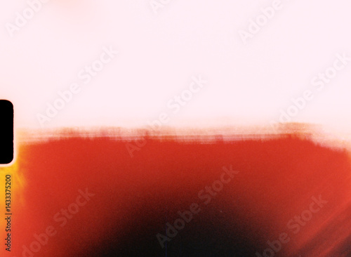 Light leak creating red gradient on damaged film material with sprocket hole