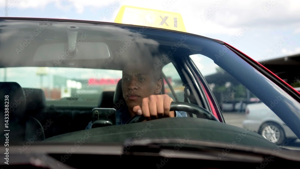 Calm African American taxi driver driving his car in the city. Yellow taxi car roof sign. People, job, service concept. Calm African American taxi driver driving his car in the city. Yellow taxi car roof sign. People, job, service concept.