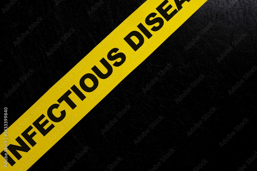 Contagious area and infectious disease caution, danger and warning concept. Yellow barricade tape with word in dark black background.