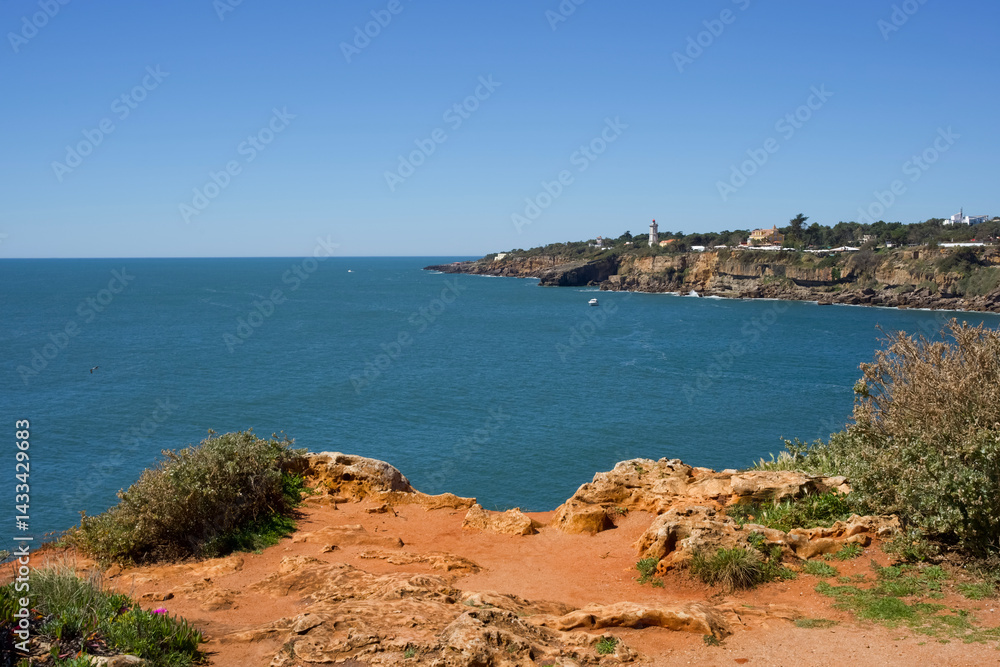 Coastal View of Rocky Shoreline with Clear Blue Water and Green Vegetation in Algarve Portugal Scenic Landscape Healthy Living Concept Coastal View of Rocky Shoreline with Clear Blue Water and Green Vegetation in Algarve Portugal Scenic Landscape Healthy Living Concept
