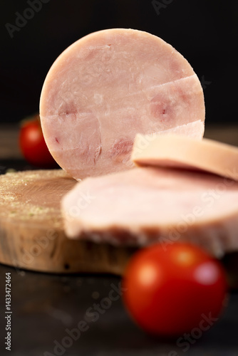 Obraz na płótnie chicken ham from different pieces of meat during slicing and ripe red tomatoes w salonie