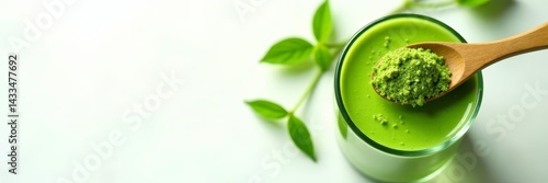 Panel kuchenny z motywem Top view of matcha green powder in wooden spoon with green drink in glass cup on white background, matcha, ingredient, green