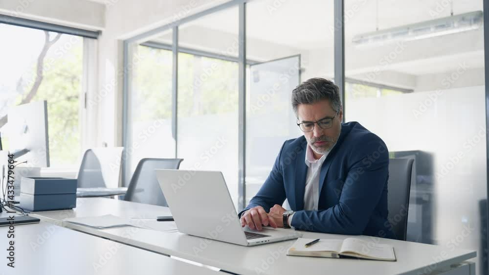 Mature 50s Latin business man ceo manager using laptop computer in office. Focused senior businessman entrepreneur sitting at desk working on financial project, typing looking at screen. Copy space Mature 50s Latin business man ceo manager using laptop computer in office. Focused senior businessman entrepreneur sitting at desk working on financial project, typing looking at screen. Copy space