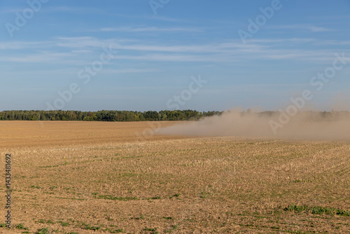Obraz na płótnie field after harvest during arable land, dry sand and dust in windy weather fly over the ground w salonie