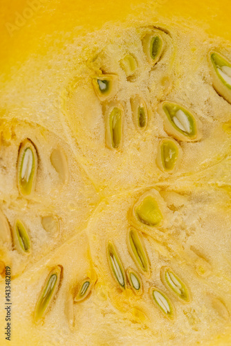 Obraz na płótnie Slice yellow-orange ripe pumpkin or zucchini, slicing ripe zucchini on a black cooking table w salonie