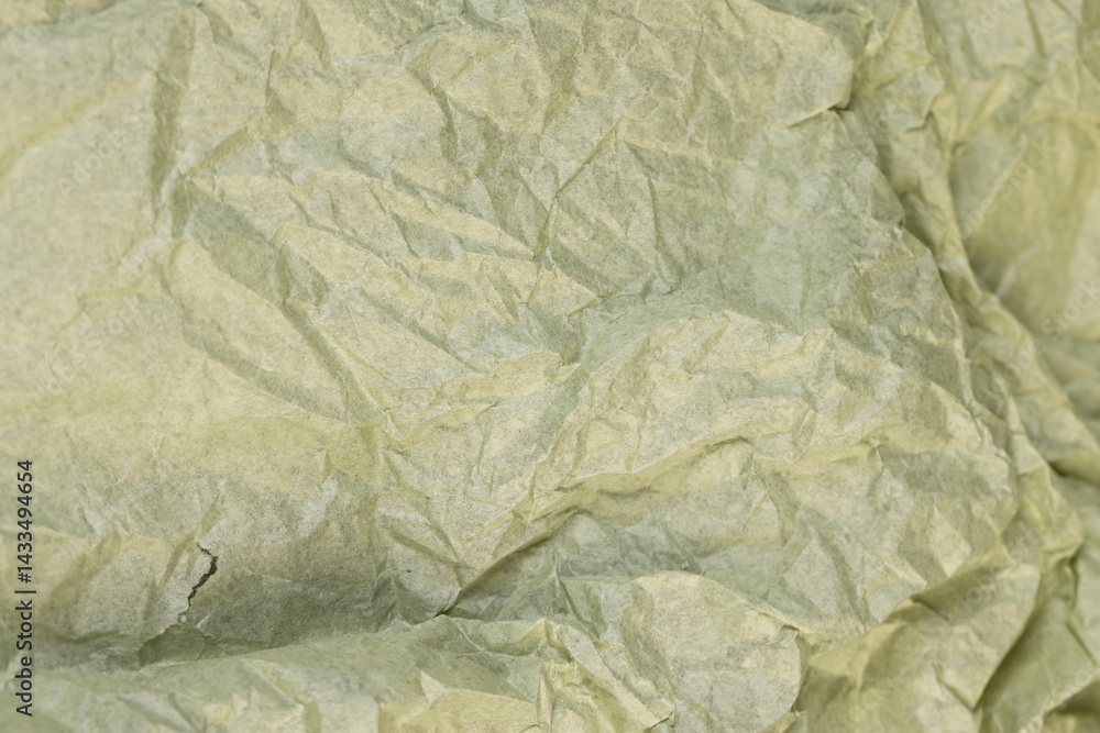 green paper for packaging , part of a sheet of paper crumpled after use