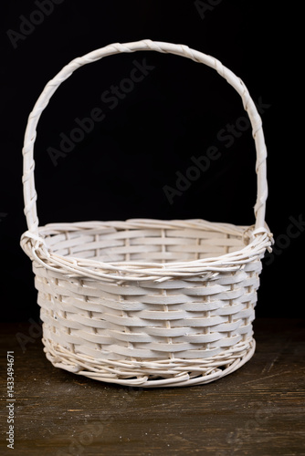 Obraz na płótnie a white basket for food or other items, natural branches painted white from which a decorative basket is woven w salonie