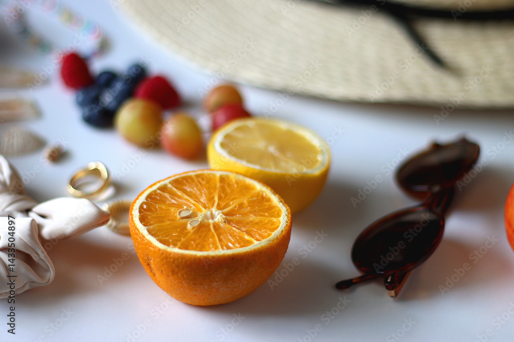 Straw hat, sunglasses, seasonal fruit, seashells and colorful accessories on white backgrounds. Cute summer essentials. Selective focus.