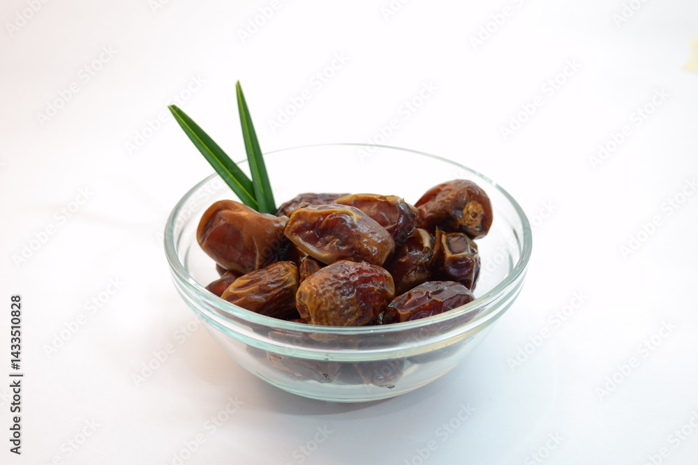 Bowl of Fresh Dates with Green Leaf on White Background Bowl of Fresh Dates with Green Leaf on White Background