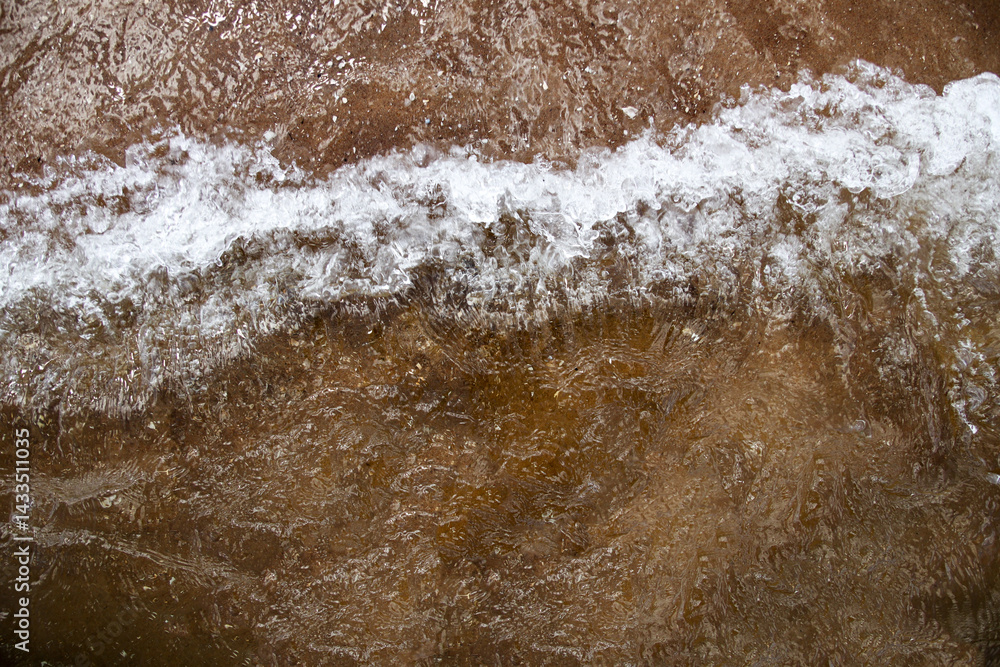 Brown sea waves rolling gently, creating a natural texture of water movement and earthy tones. serene coastal scene with soft wave patterns. Sea storm background