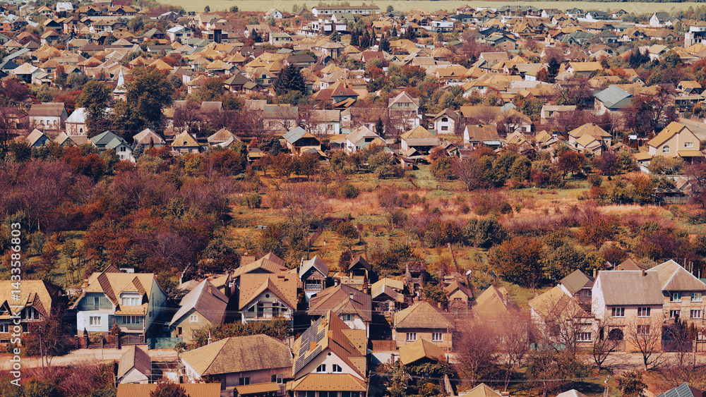 Obraz premium Panoramic autumn view of houses in Mukachevo, Zakarpattia, with mountain backdrop