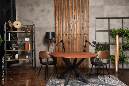 Creative podcast studio featuring a circular table and dual microphones set up for an engaging interview session
