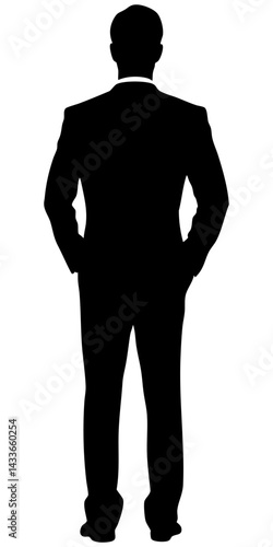 Silhouette of a man in a suit standing with hands in pockets facing away from the viewer