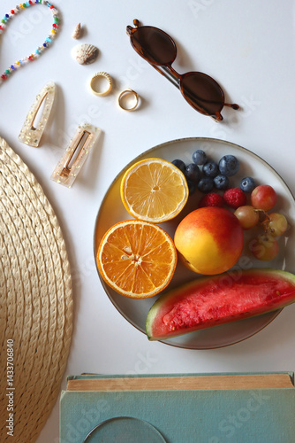 Obraz na płótnie Glass of cocktail, straw hat, sunglasses, books, fresh fruit, chocolate and accessories. Summer essentials on the table. Top view. w salonie