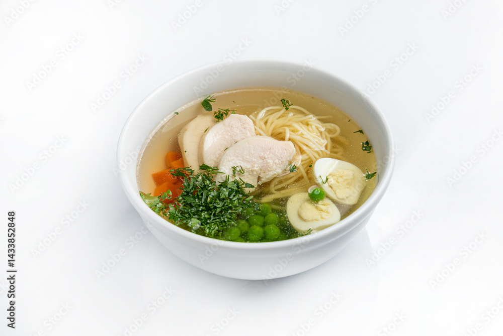 Chicken soup with noodles and vegetables in a bowl isolated on white background Chicken soup with noodles and vegetables in a bowl isolated on white background
