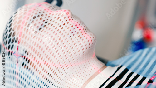 A young woman wearing an immobilization mask for radiotherapy lies in a CT capsule for precise diagnosis of the location of a tumor in the brain. Concepcion of modern medical technology.