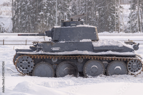A German tank from the Second World War. Armored tracked vehicles. Tank troops. A tank in snow drifts. Tanks move across the field through snow drifts.