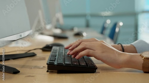 close up of asian women typing on a lab computer keyboard