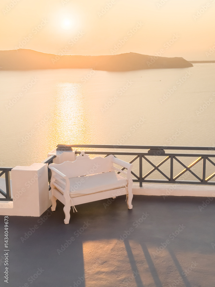 Beautiful sunset at Santorini island, Greece. Chair on the terrace with sea view.