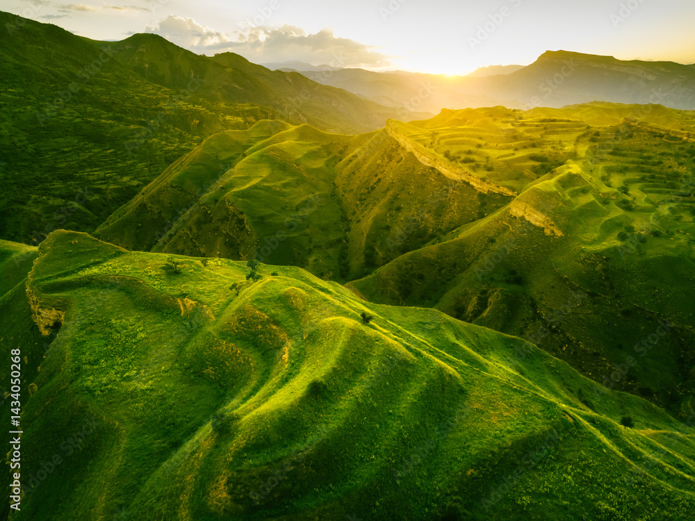 View of the green agricultural terraces in the mountains at sunset. Chokh village in Dagestan, Russia.