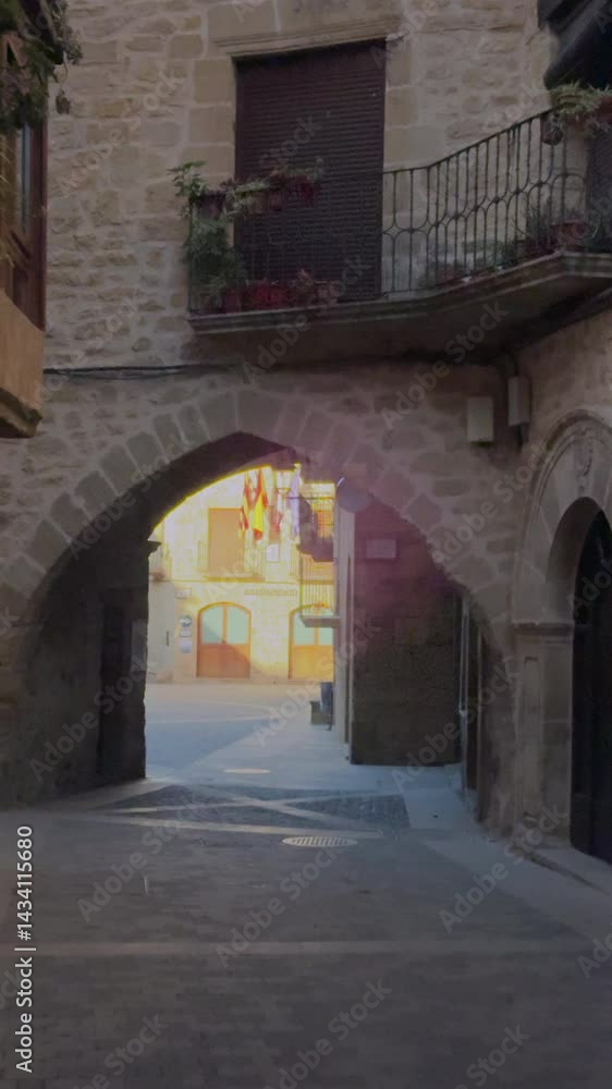 Cyclist passing under arch in european town Cyclist passing under arch in european town