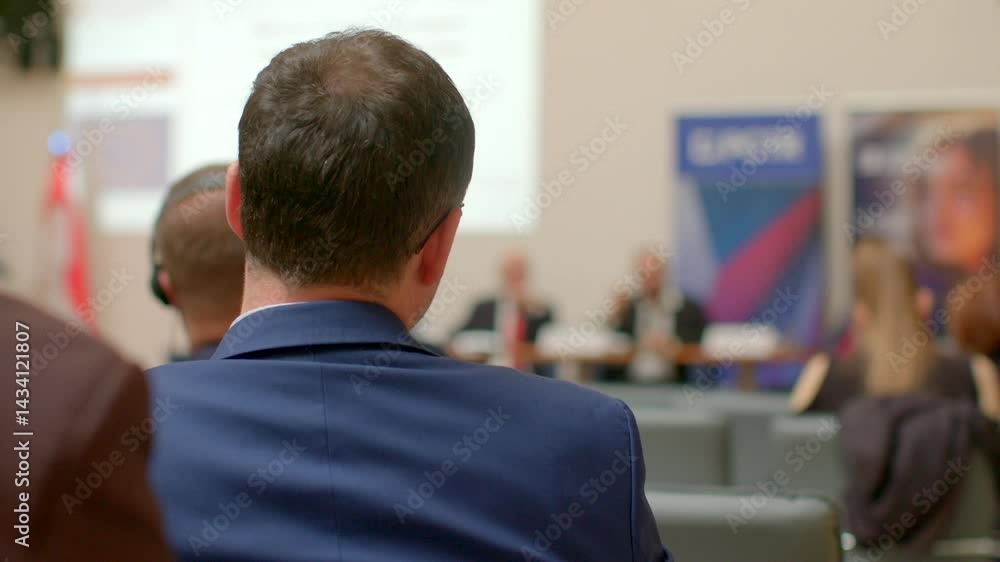 Attendees at a conference enjoy presentations and engaging promotional backgrounds enhancing their experience Attendees at a conference enjoy presentations and engaging promotional backgrounds enhancing their experience