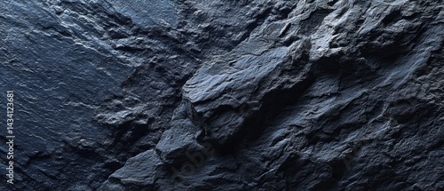Moody close up of a stunning dark blue rock surface with intricate textures and captivating shadows creating a dramatic and visually appealing stone background
