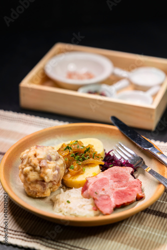 Obraz na płótnie Bavarian dumplings with roasted pork, sauerkraut and potato dumpling lying on a plate w salonie