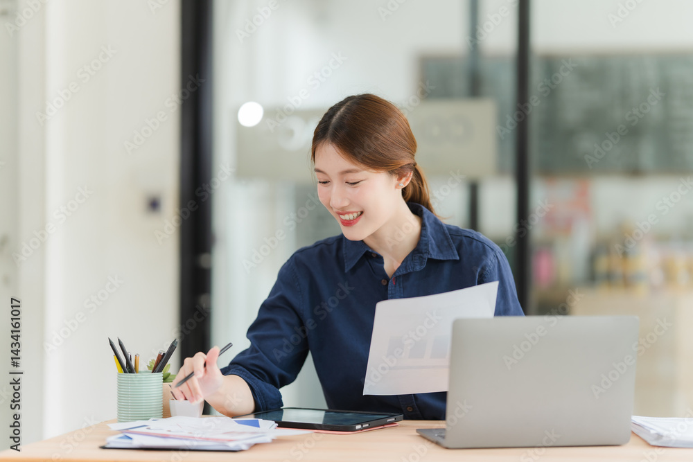 Fototapeta premium Smiling Young Woman Analyzing Business Data