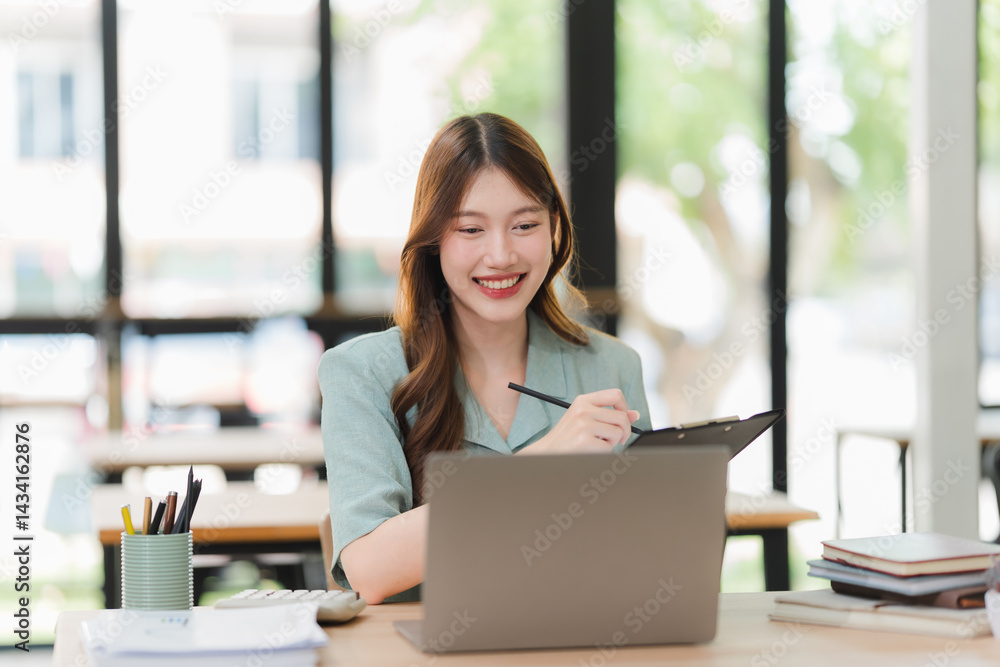 Smiling Asian Woman Working at Desk Smiling Asian Woman Working at Desk