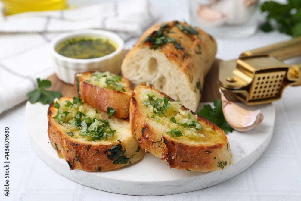 Tasty bread with garlic, herbs and oil on white tiled table, closeup Tasty bread with garlic, herbs and oil on white tiled table, closeup