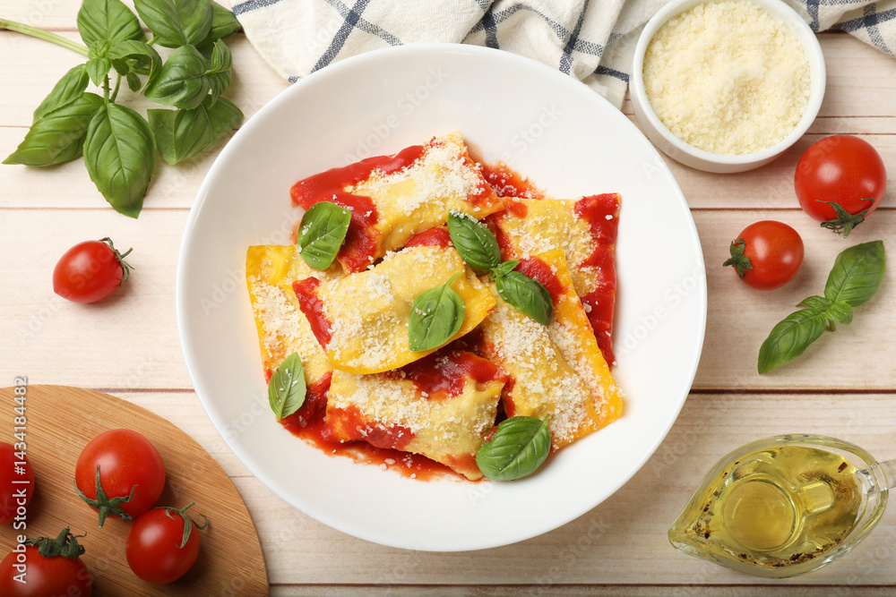 Delicious ravioli with tomato sauce, parmesan cheese and basil on white wooden table, flat lay Delicious ravioli with tomato sauce, parmesan cheese and basil on white wooden table, flat lay