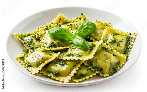 Homemade ravioli pasta, filled and topped with vibrant green pesto sauce and fresh basil leaves, served in a white bowl.